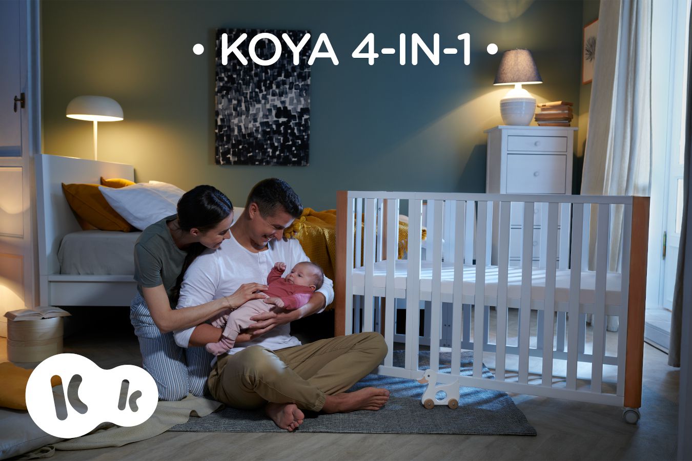 At home, parents are sitting with a baby next to the KOYA cot - text: KOYA 4IN1.